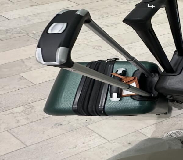 Lost Green carey on luggage with a brown name tag